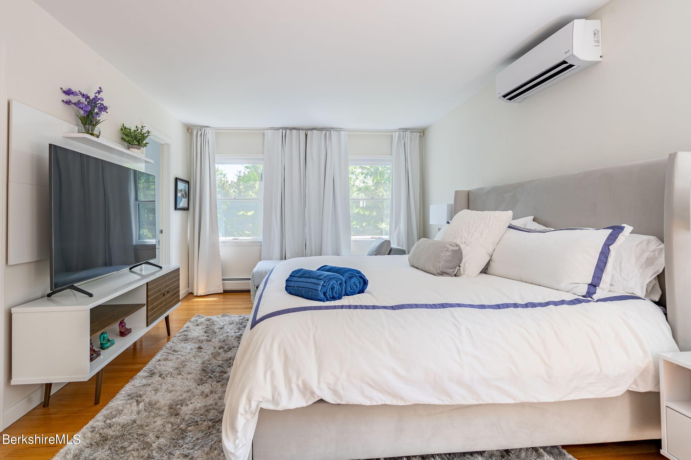 91 Brush Hill Road Great Barrington, MA 01230 - Photo 21 of 40 a bedroom with a bed and a flat screen tv