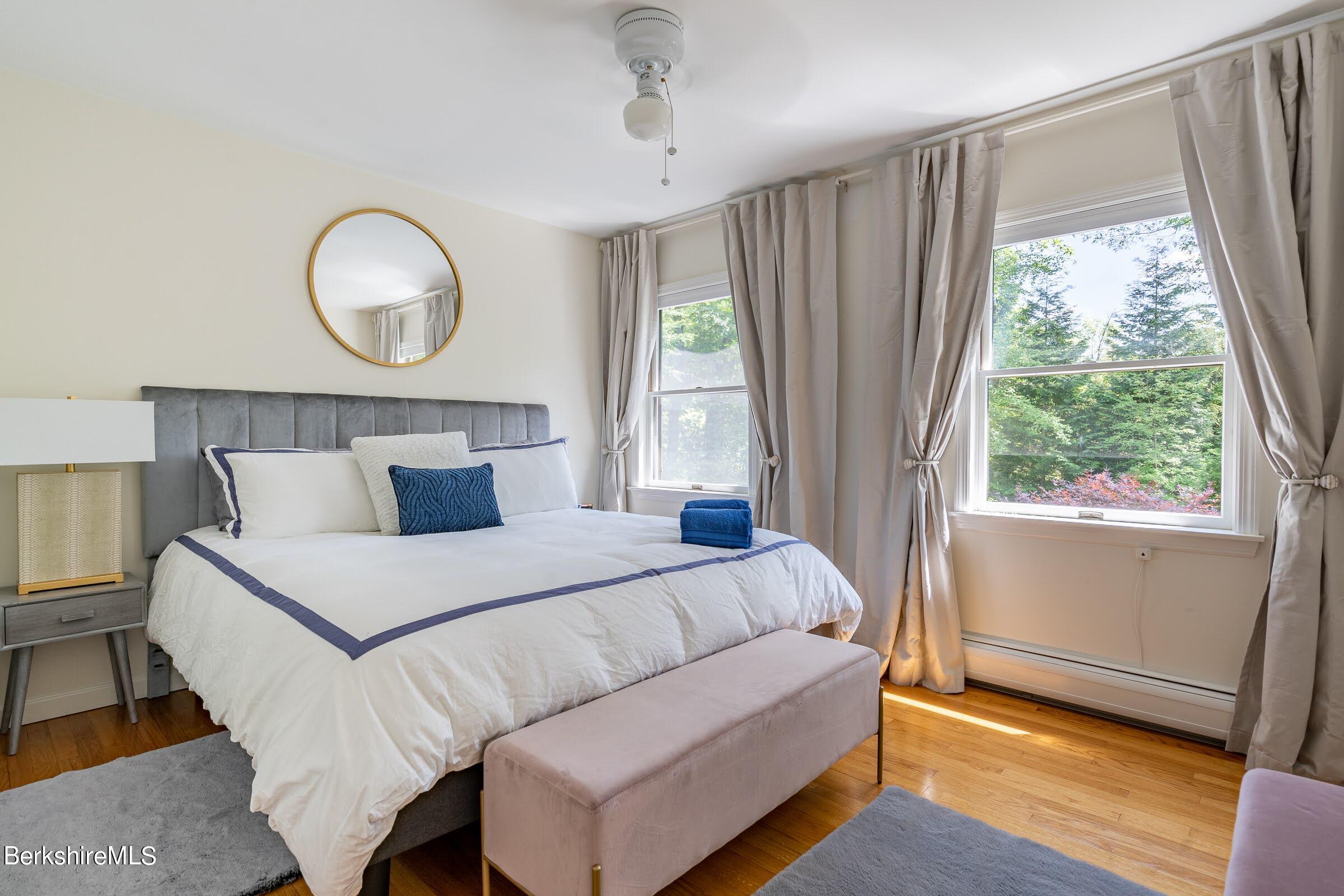 91 Brush Hill Road Great Barrington, MA 01230 - Photo 23 of 40 a bedroom with a bed mirror and window