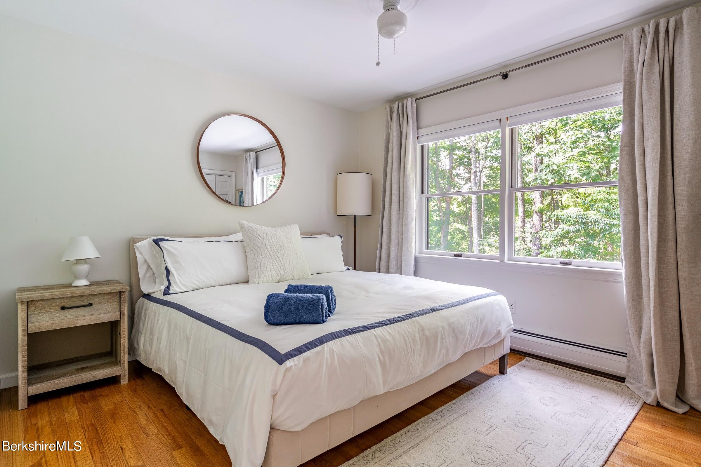 91 Brush Hill Road Great Barrington, MA 01230 - Photo 25 of 40 a bedroom with a bed and a large window