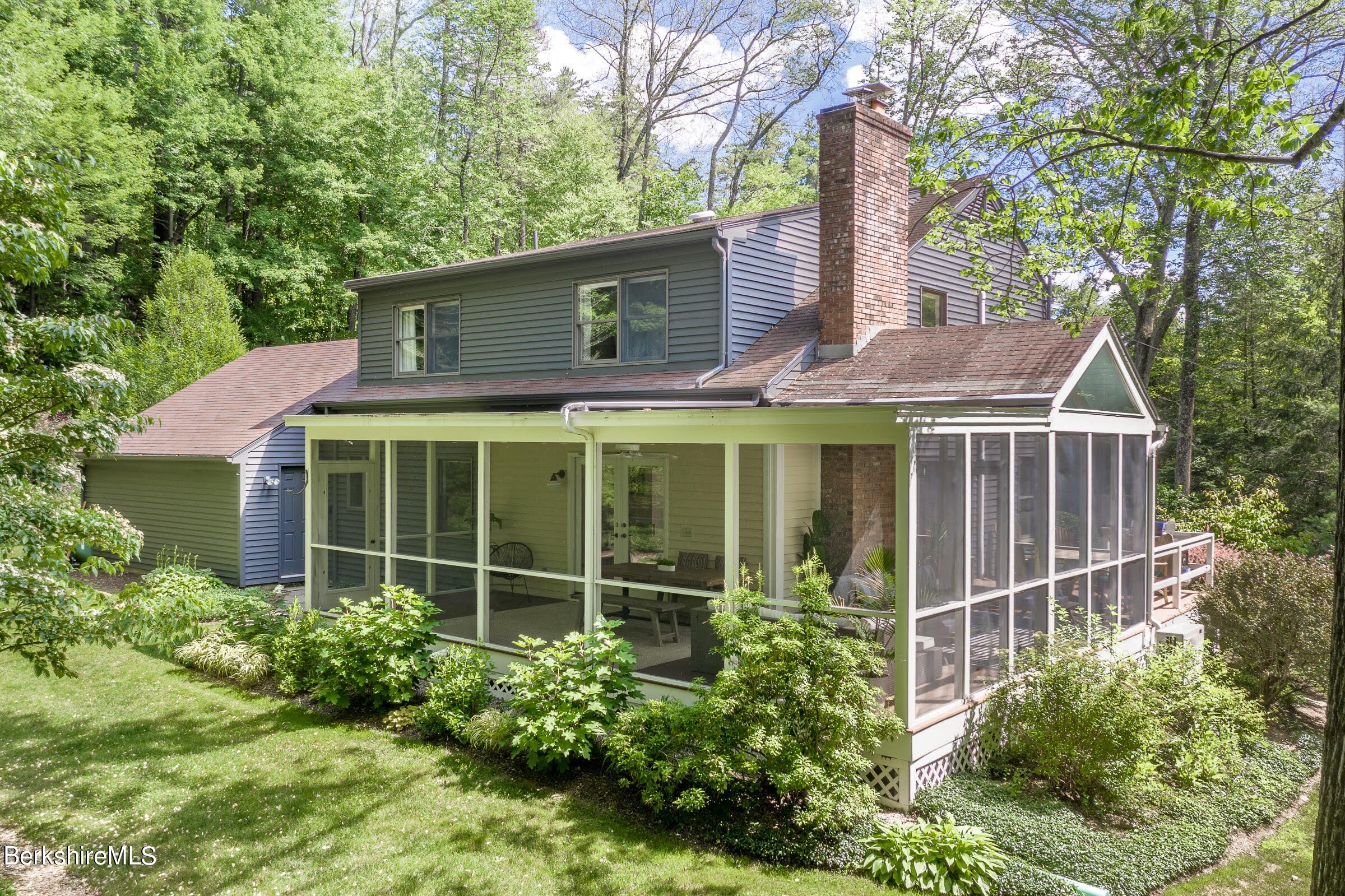 91 Brush Hill Road Great Barrington, MA 01230 - Photo 27 of 40 a front view of a house with a garden