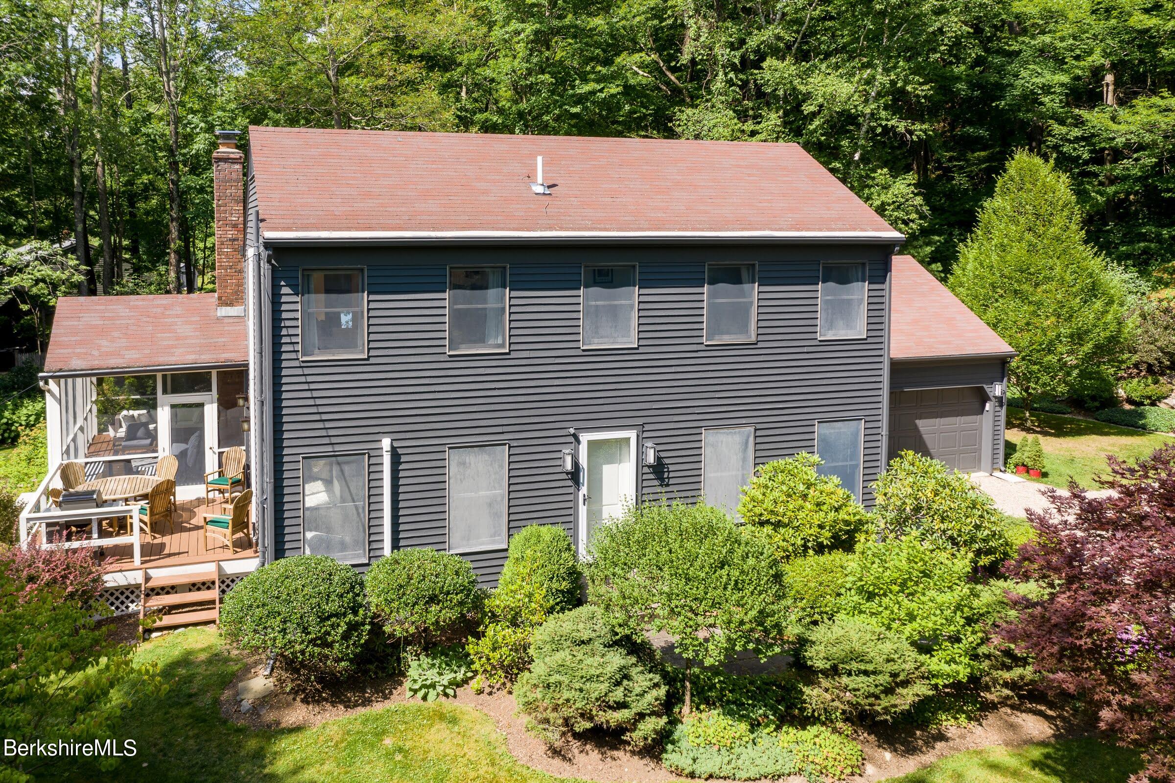 91 Brush Hill Road Great Barrington, MA 01230 - Photo 33 of 40 a front view of a house with garden
