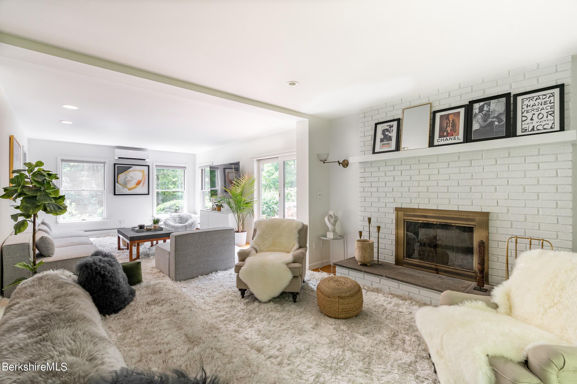 91 Brush Hill Road Great Barrington, MA 01230 - Photo 7 of 40 a living room with furniture potted plant and a fireplace
