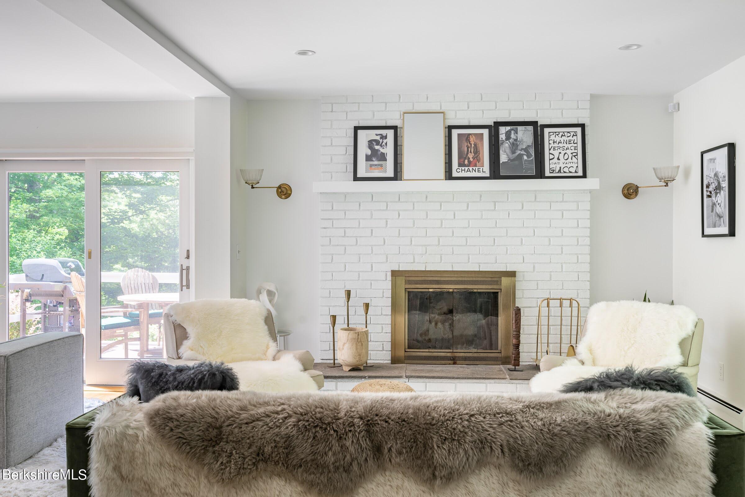 91 Brush Hill Road Great Barrington, MA 01230 - Photo 10 of 40 a bedroom with a bed and a fireplace