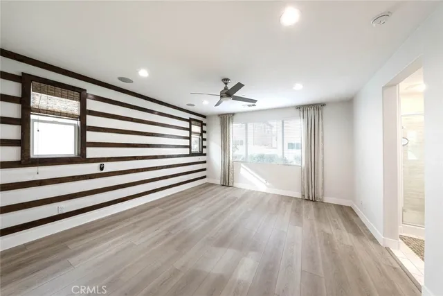 a view of a room with wooden floors and window