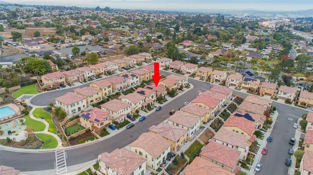 an aerial view of residential houses with outdoor space