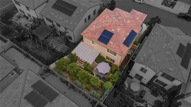 an aerial view of a house with a yard