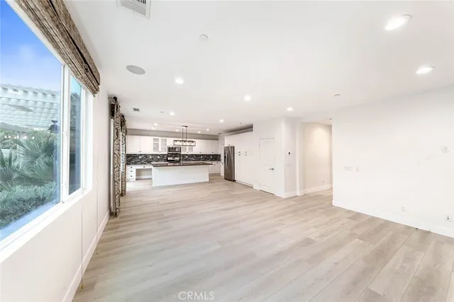 a view of a living room a refrigerator and a stove