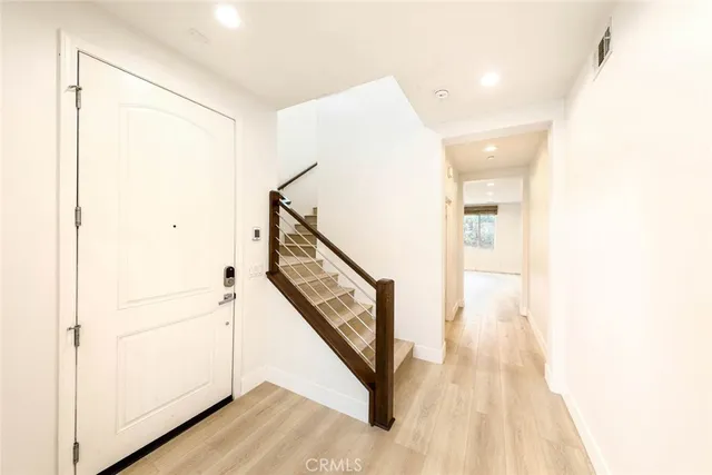 a view of an entryway with wooden floor
