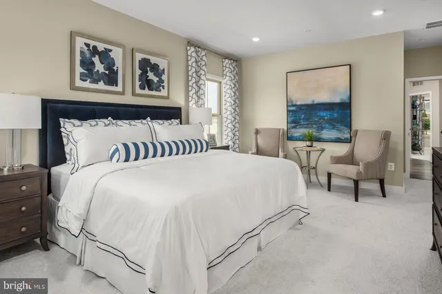 a bedroom with a bed and a painting on the wall