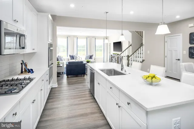 a large white kitchen with a large window