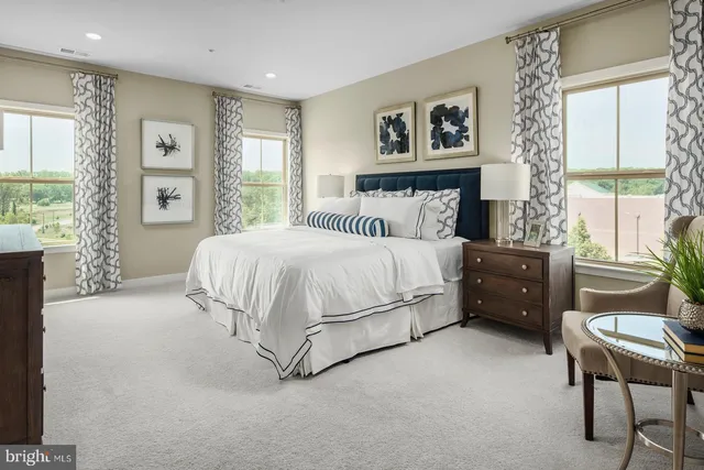 a bedroom with a bed a couch and a window