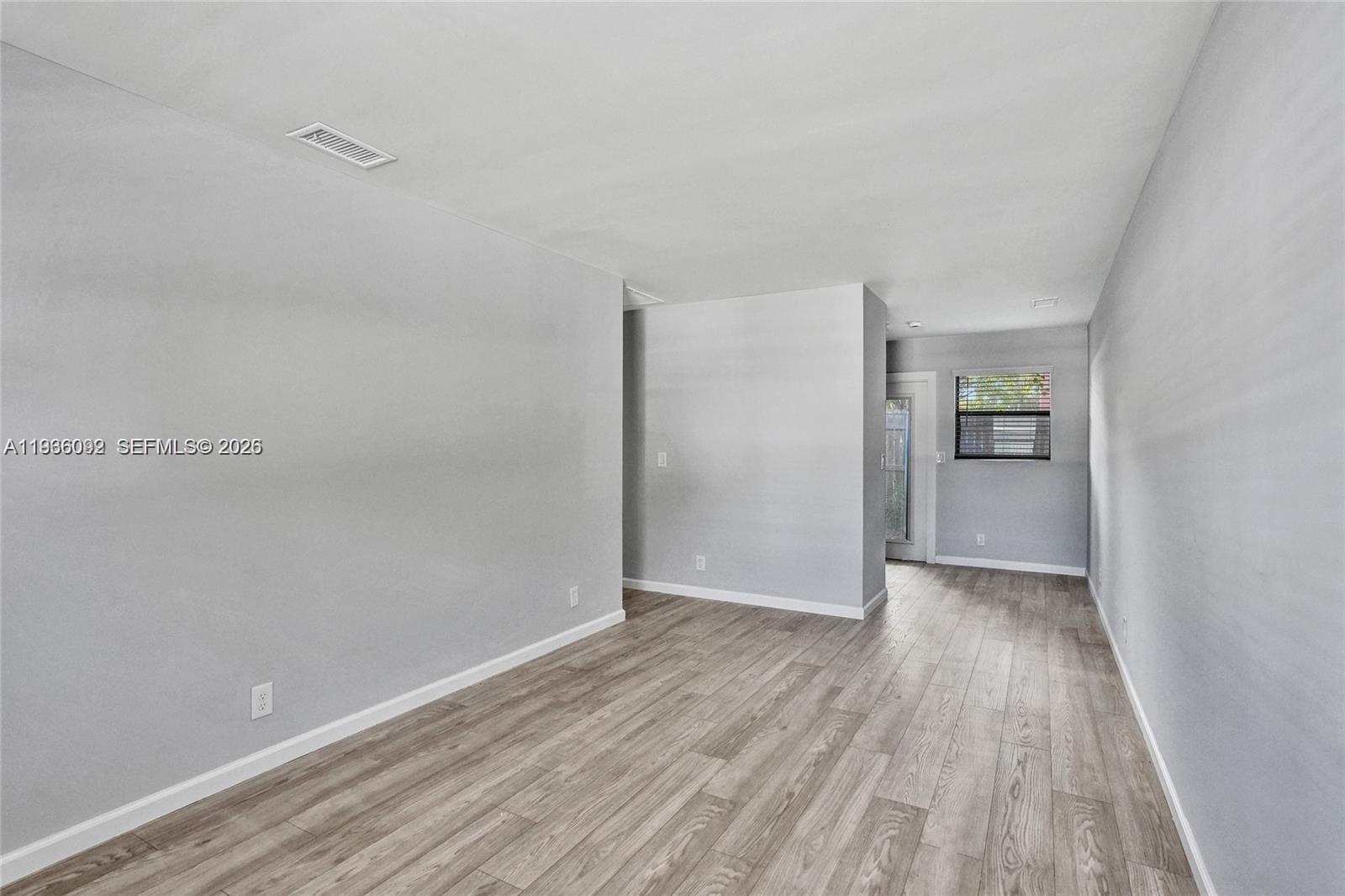 1200 West 31st Street, Unit B Riviera Beach, FL 33404 - Photo 12 of 20 a view of an empty room and wooden floor