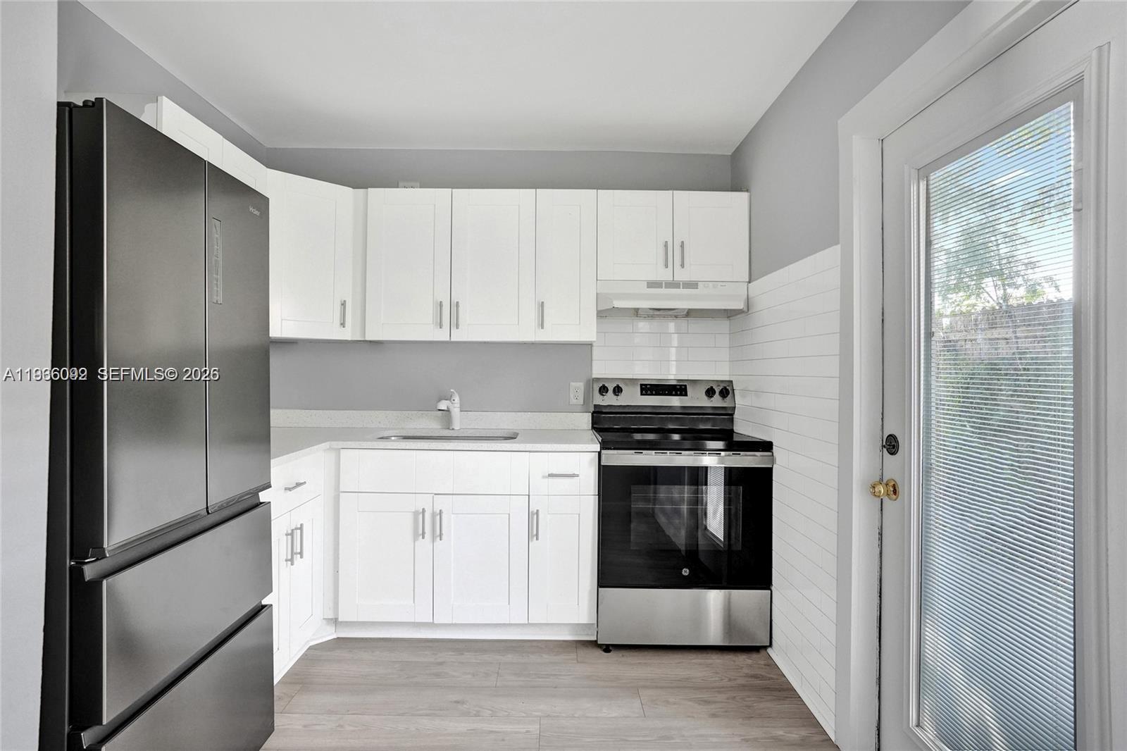 1200 West 31st Street, Unit B Riviera Beach, FL 33404 - Photo 15 of 20 a kitchen with a stove and a refrigerator