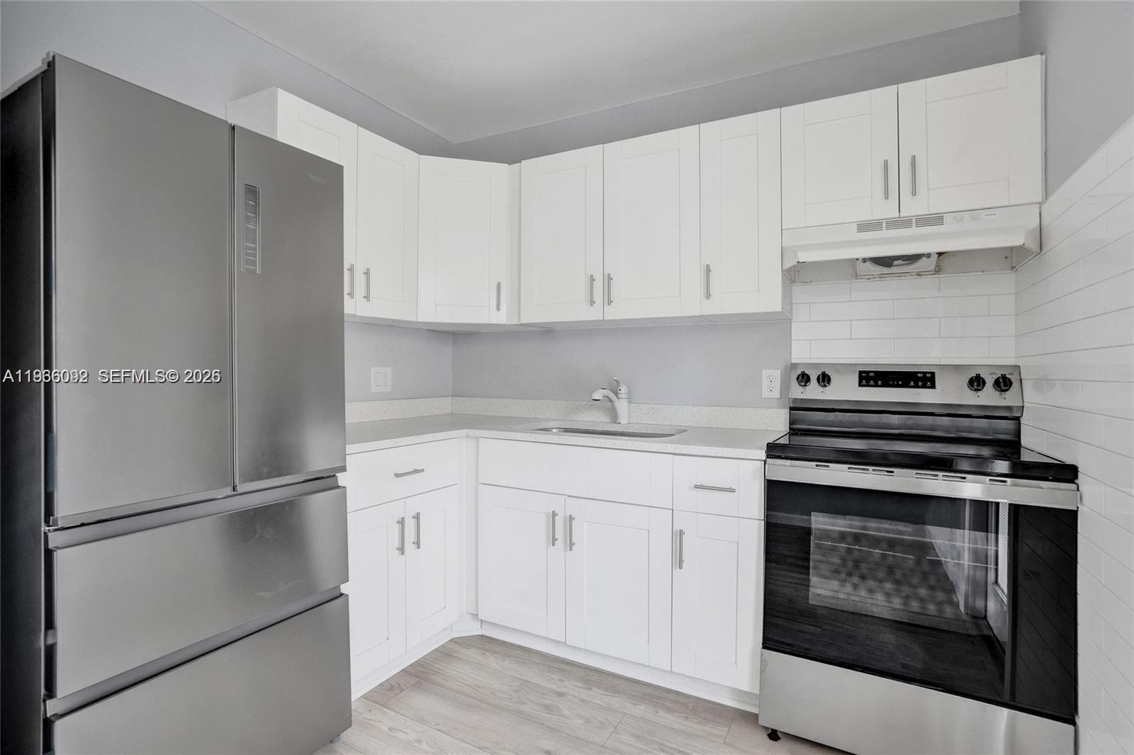 1200 West 31st Street, Unit B Riviera Beach, FL 33404 - Photo 16 of 20 a kitchen with cabinets appliances and a sink
