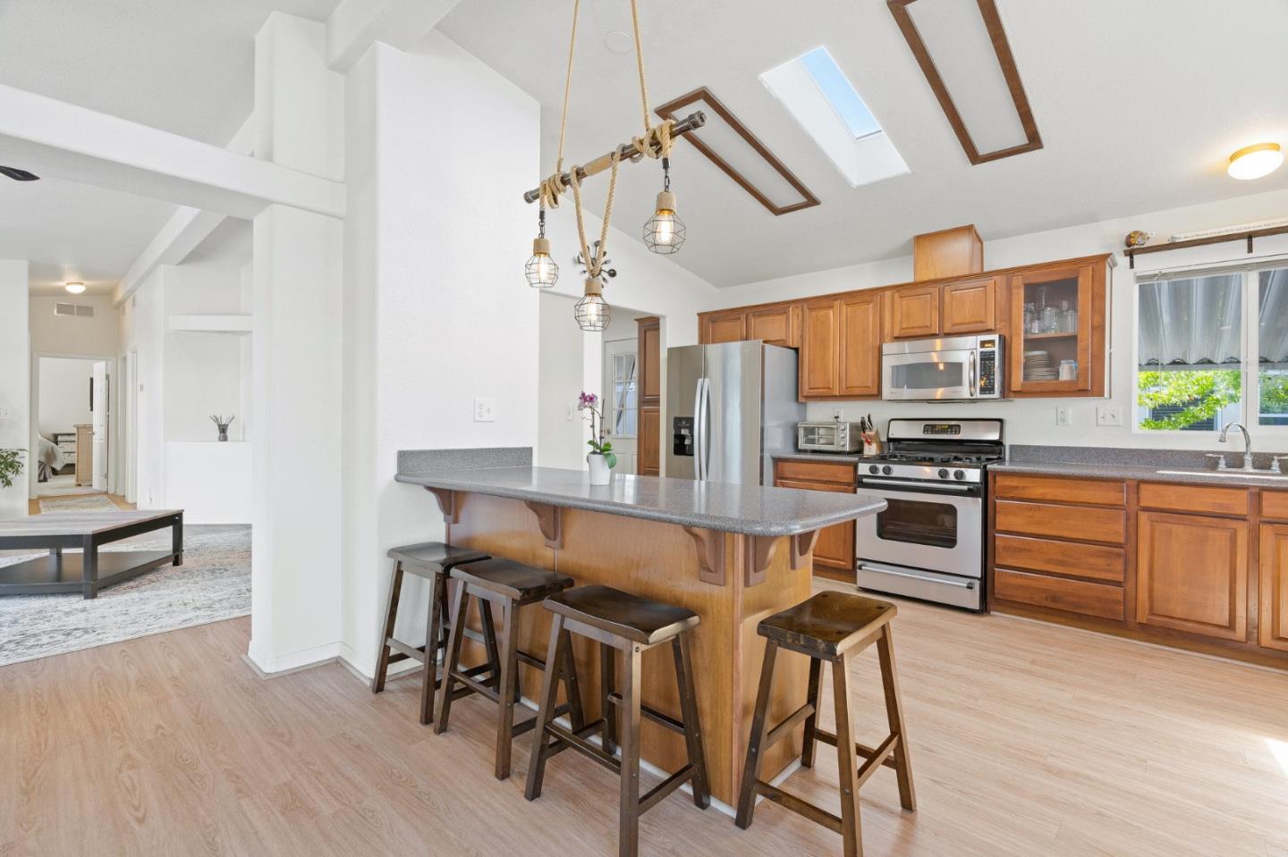 100 North Rodeo Gulch Road, Unit 31 Soquel, CA 95073 - Photo 11 of 38 a kitchen with stainless steel appliances kitchen island wooden floors and refrigerator