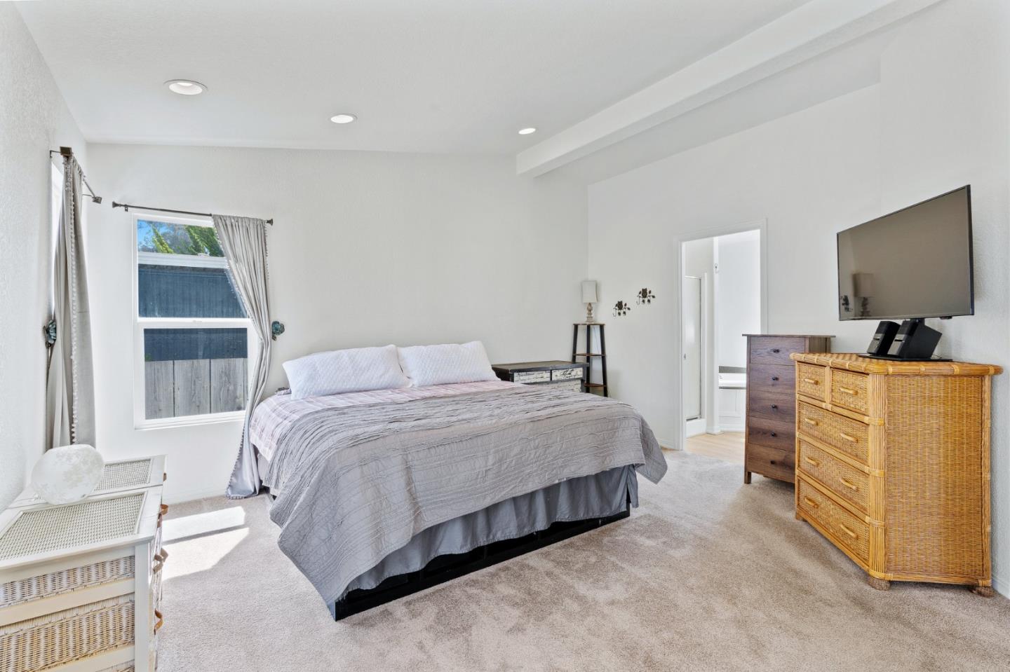 100 North Rodeo Gulch Road, Unit 31 Soquel, CA 95073 - Photo 18 of 38 a bedroom with a bed and a flat tv screen