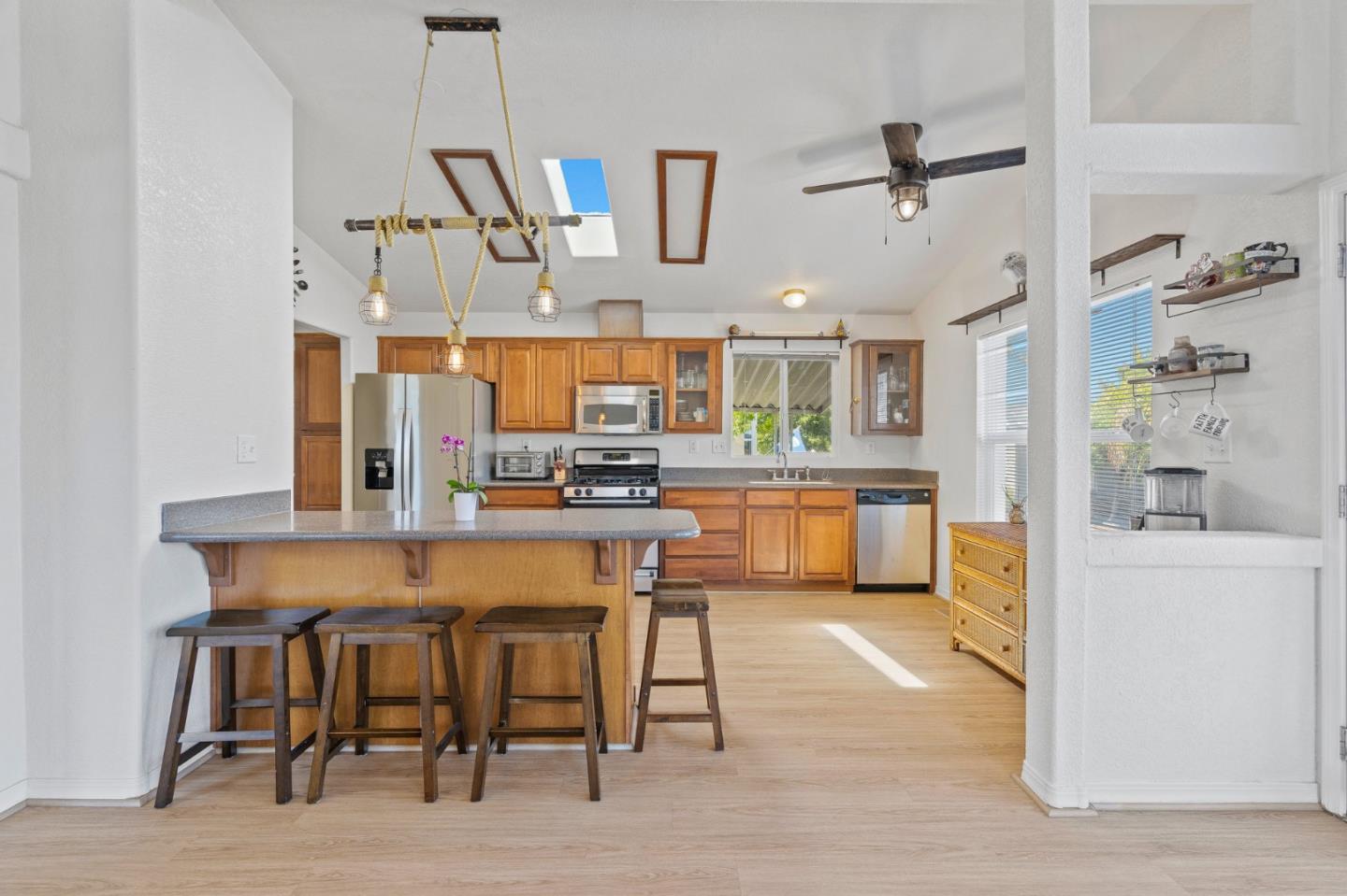 100 North Rodeo Gulch Road, Unit 31 Soquel, CA 95073 - Photo 10 of 38 a kitchen with stainless steel appliances kitchen island a table and chairs in it