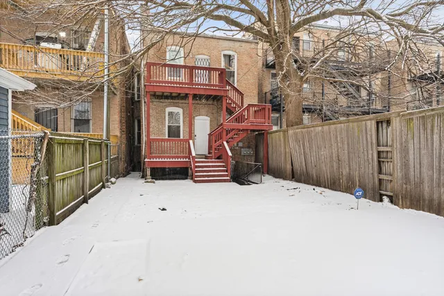 a pathway of a house with wooden fence