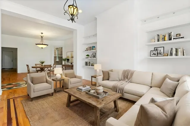 a living room with furniture a rug and a chandelier