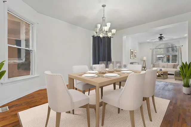 a view of a dining room with furniture and chandelier