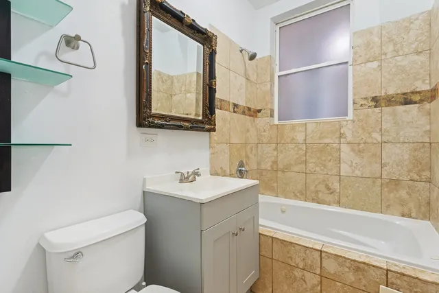 a bathroom with a sink a toilet and mirror