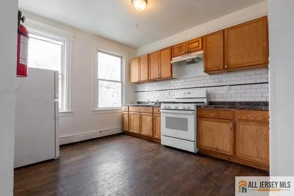 a kitchen with a stove a sink and a microwave