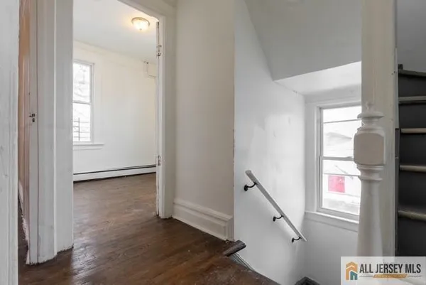 a view of an entryway with wooden floor