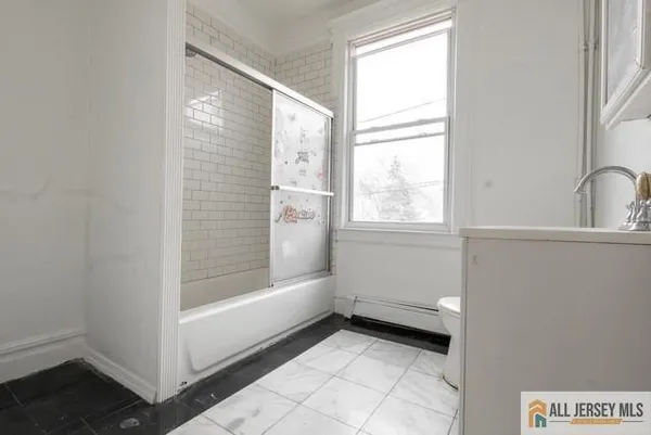 a bathroom with a bathtub and shower