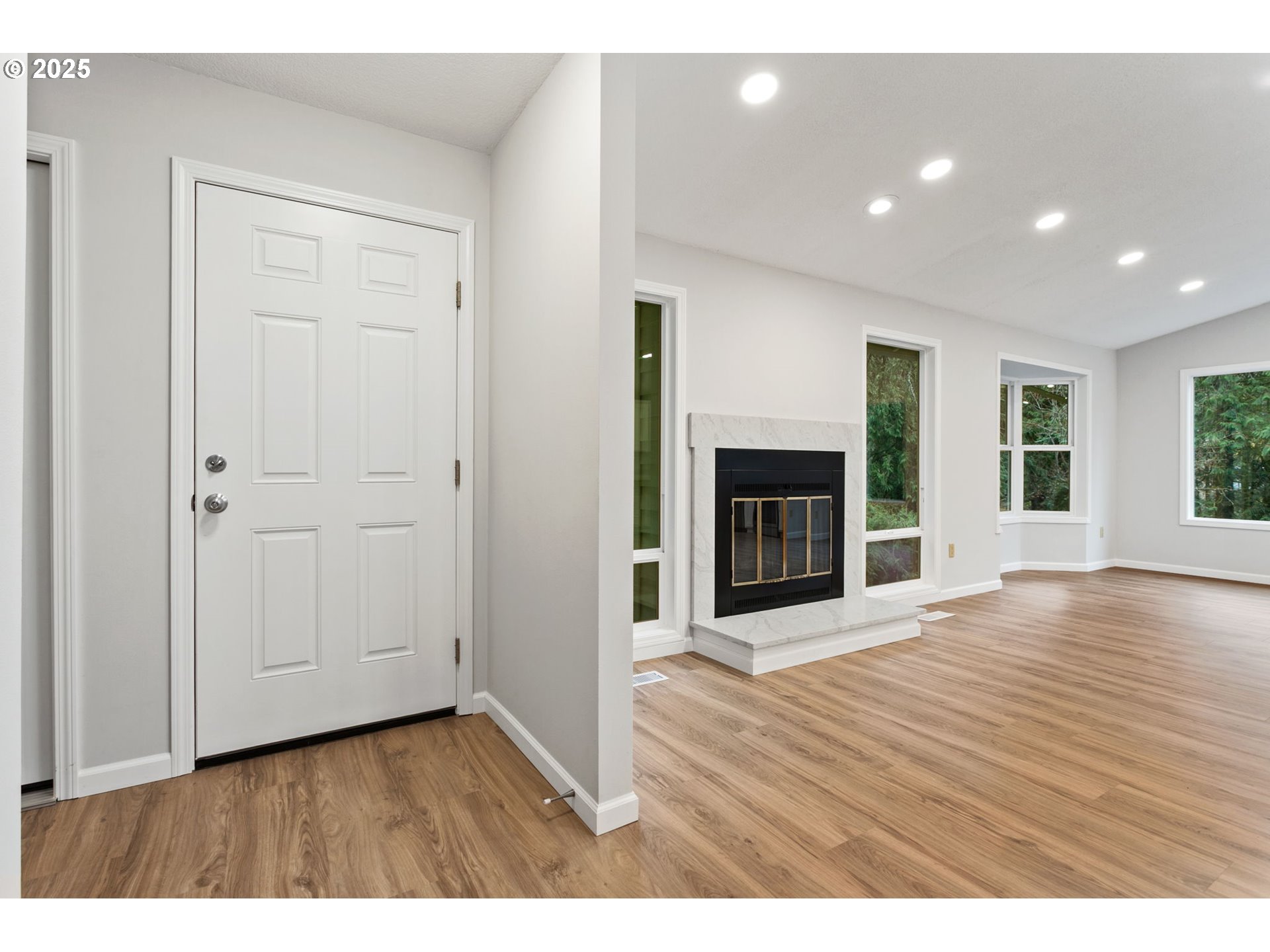 6647 Southeast 122nd Avenue Portland, OR 97266 - Photo 15 of 48 an empty room with wooden floor fireplace and windows