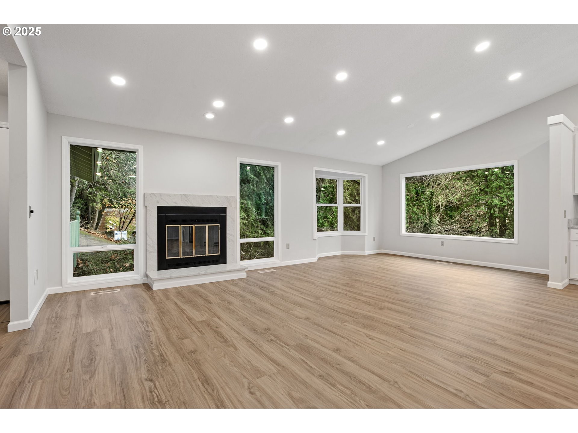 6647 Southeast 122nd Avenue Portland, OR 97266 - Photo 16 of 48 a view of an empty room with wooden floor and a window