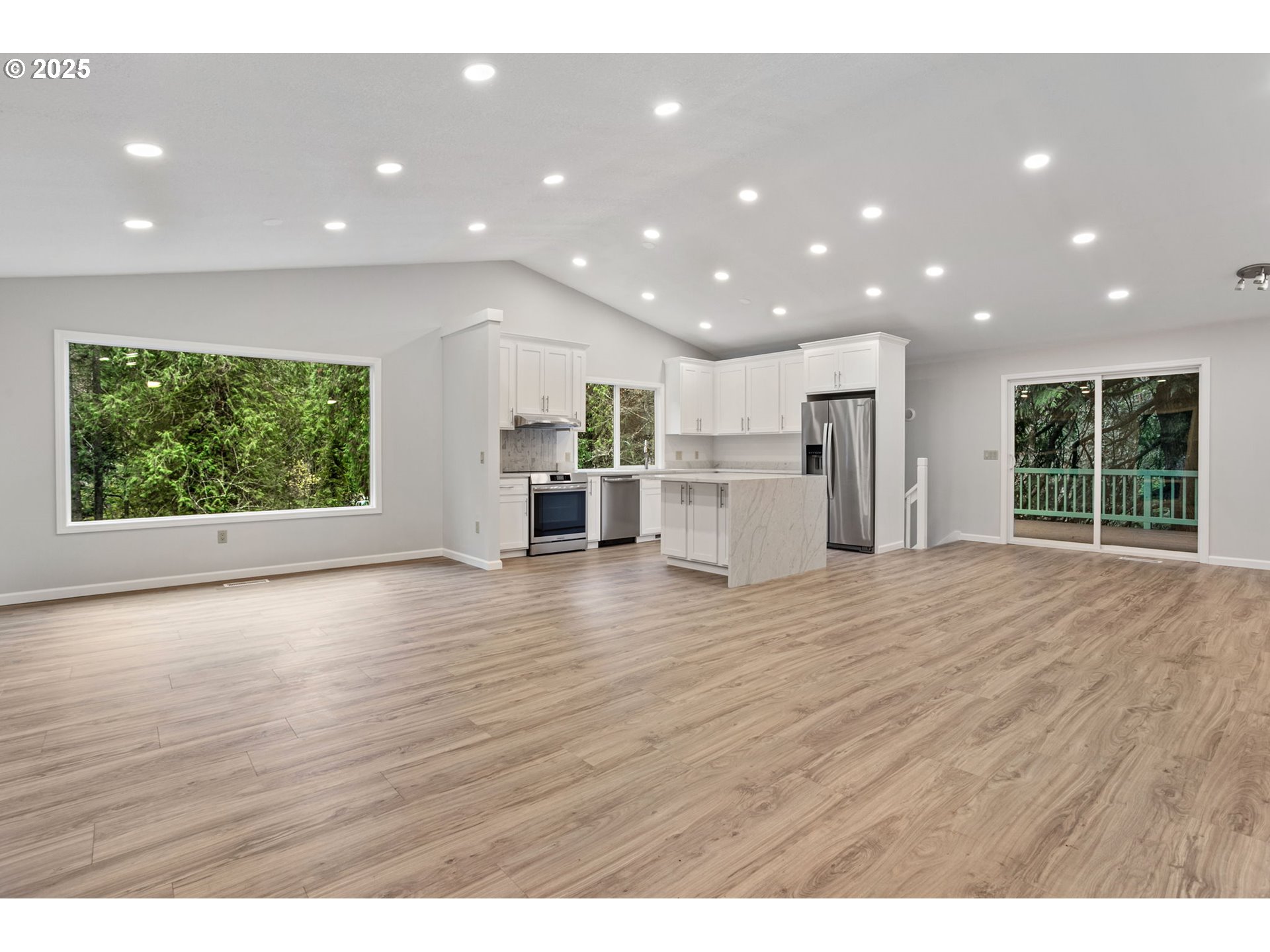 6647 Southeast 122nd Avenue Portland, OR 97266 - Photo 18 of 48 a view of an empty room with wooden floor and a window
