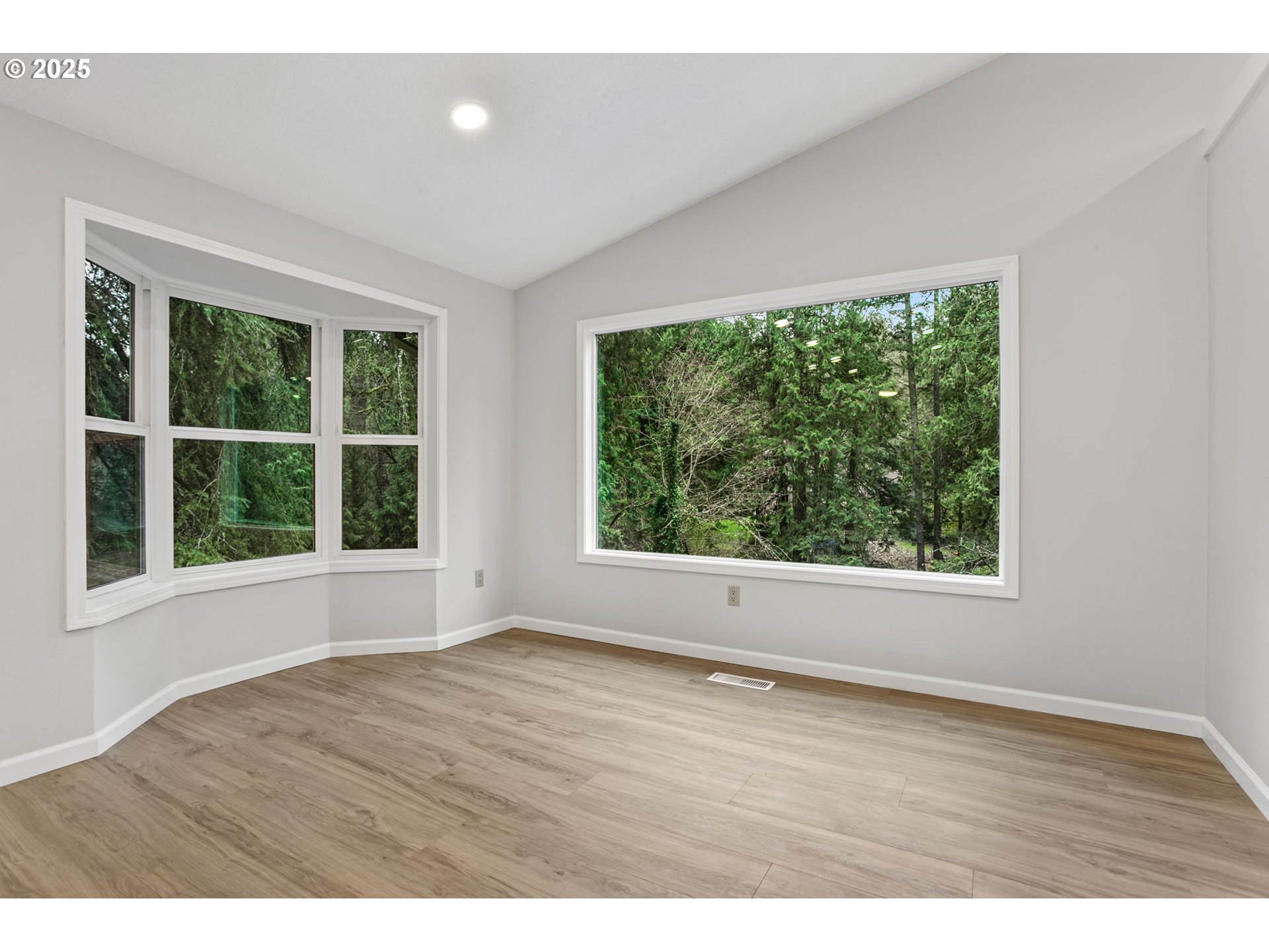 6647 Southeast 122nd Avenue Portland, OR 97266 - Photo 19 of 48 an empty room with wooden floor and windows