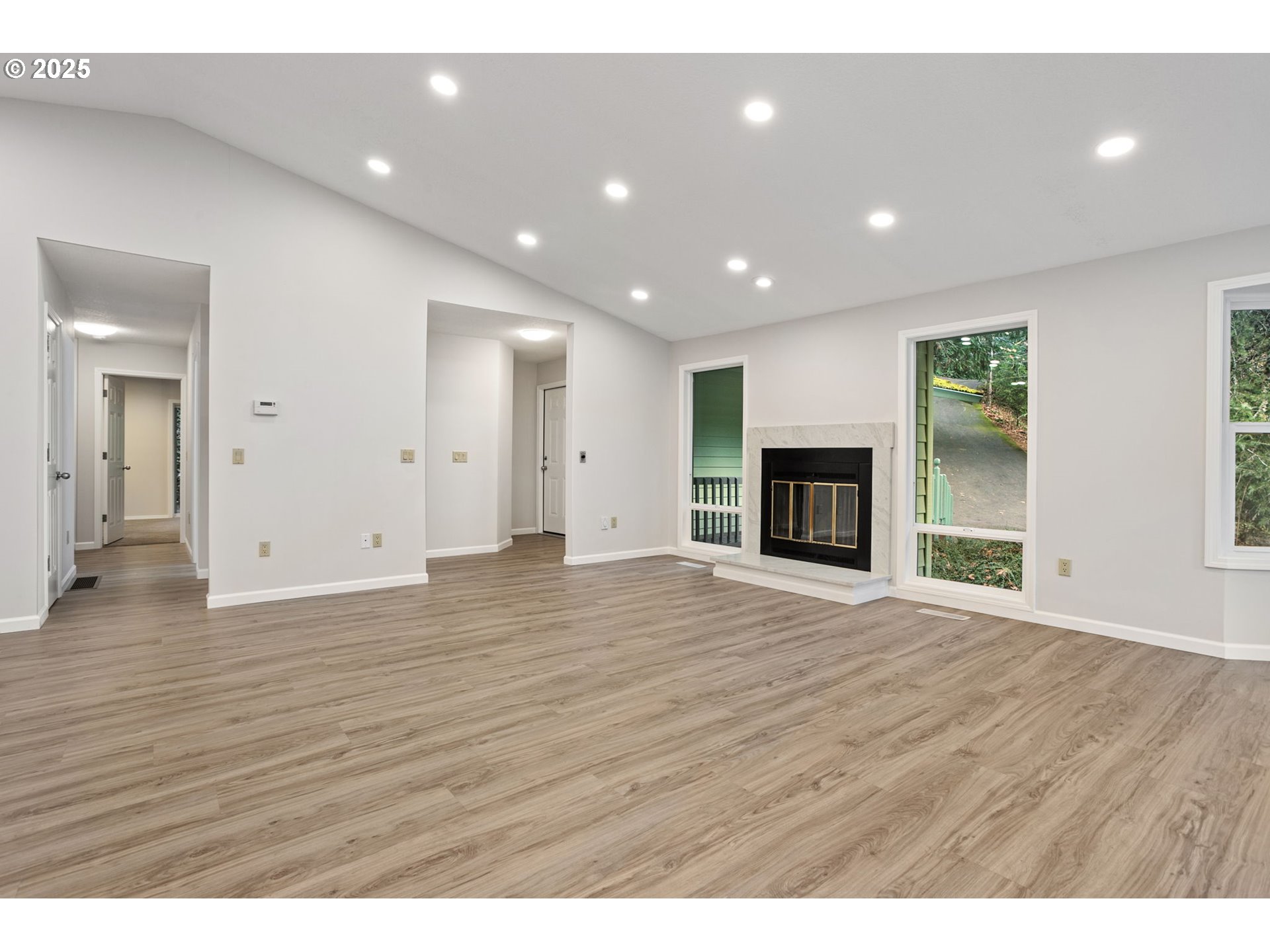 6647 Southeast 122nd Avenue Portland, OR 97266 - Photo 25 of 48 a view of an empty room with wooden floor and a window