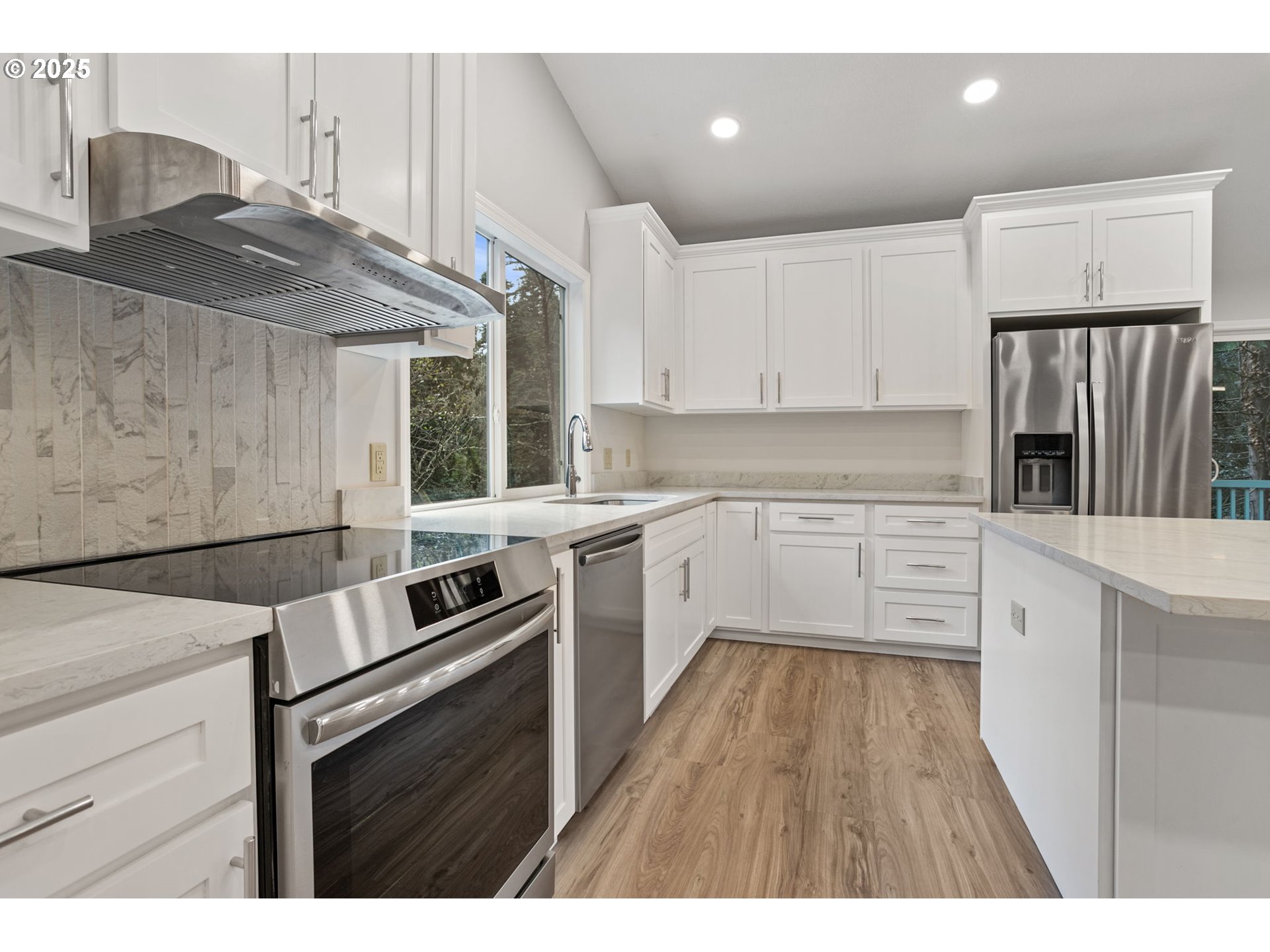 6647 Southeast 122nd Avenue Portland, OR 97266 - Photo 29 of 48 a kitchen with granite countertop a sink stainless steel appliances and cabinets