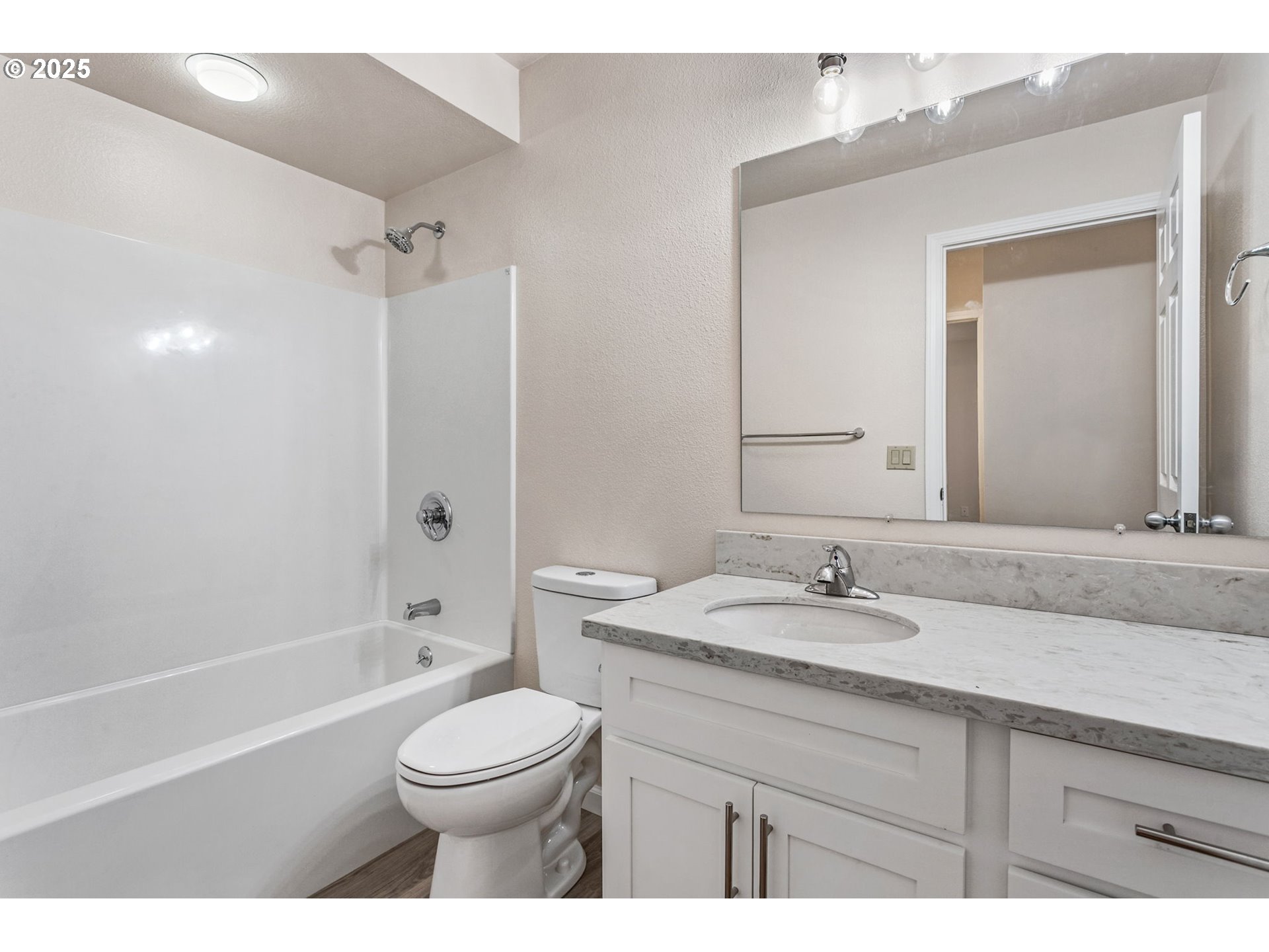 6647 Southeast 122nd Avenue Portland, OR 97266 - Photo 32 of 48 a bathroom with a sink a toilet and a mirror