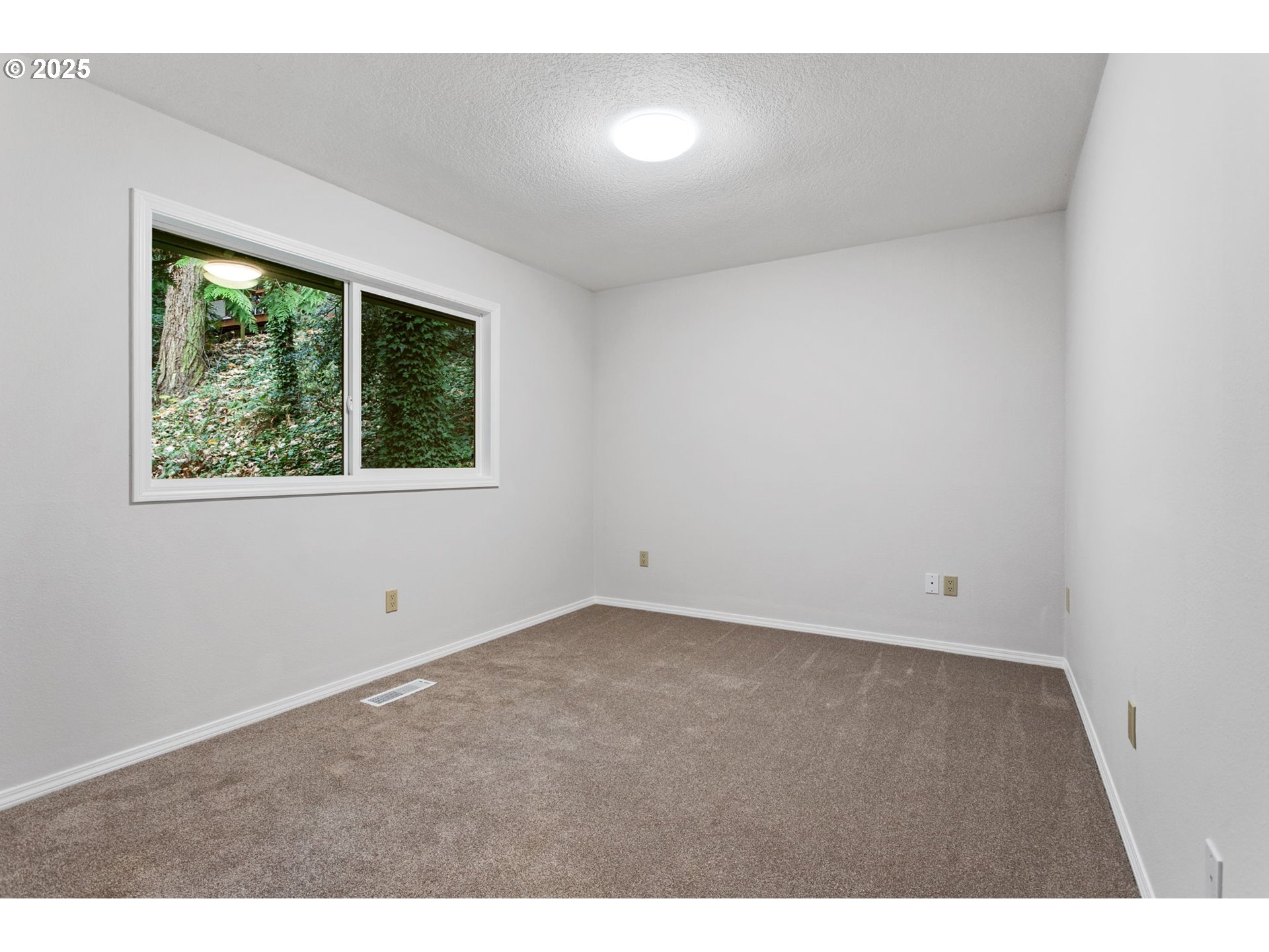 6647 Southeast 122nd Avenue Portland, OR 97266 - Photo 39 of 48 a view of an empty room with a window