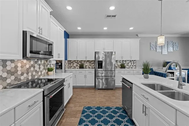 a kitchen with a sink stove and refrigerator
