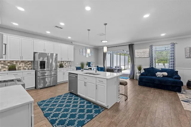 a living room with furniture and a chandelier
