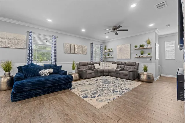 a living room with fireplace furniture and a flat screen tv