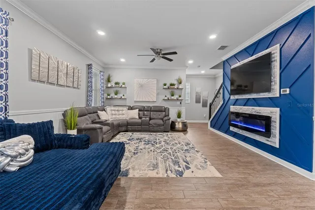 a living room with furniture ceiling fan and a rug