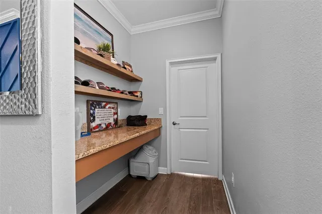 a view of a hallway with wooden floor and stairs