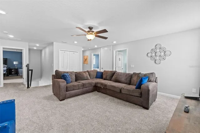 a spacious bedroom with a bed and a dresser