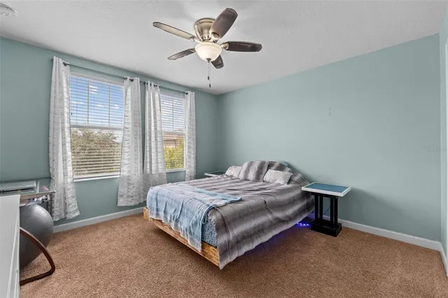 a spacious bedroom with a bed and a window