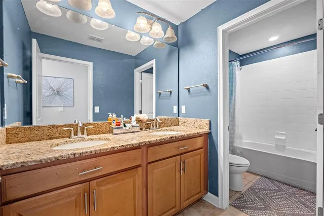 a view of walk in closet with clothes