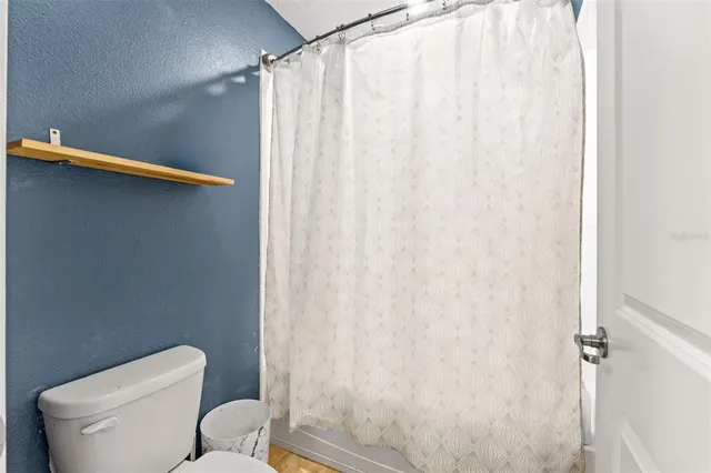 a bedroom with furniture and a large window