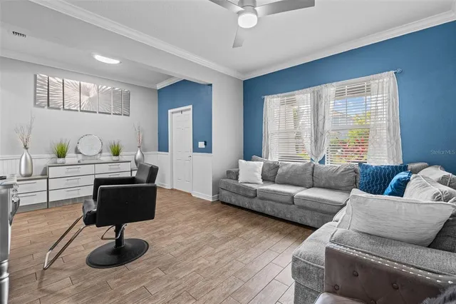 a living room with furniture and a potted plant