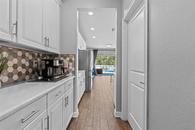 a kitchen with white cabinets
