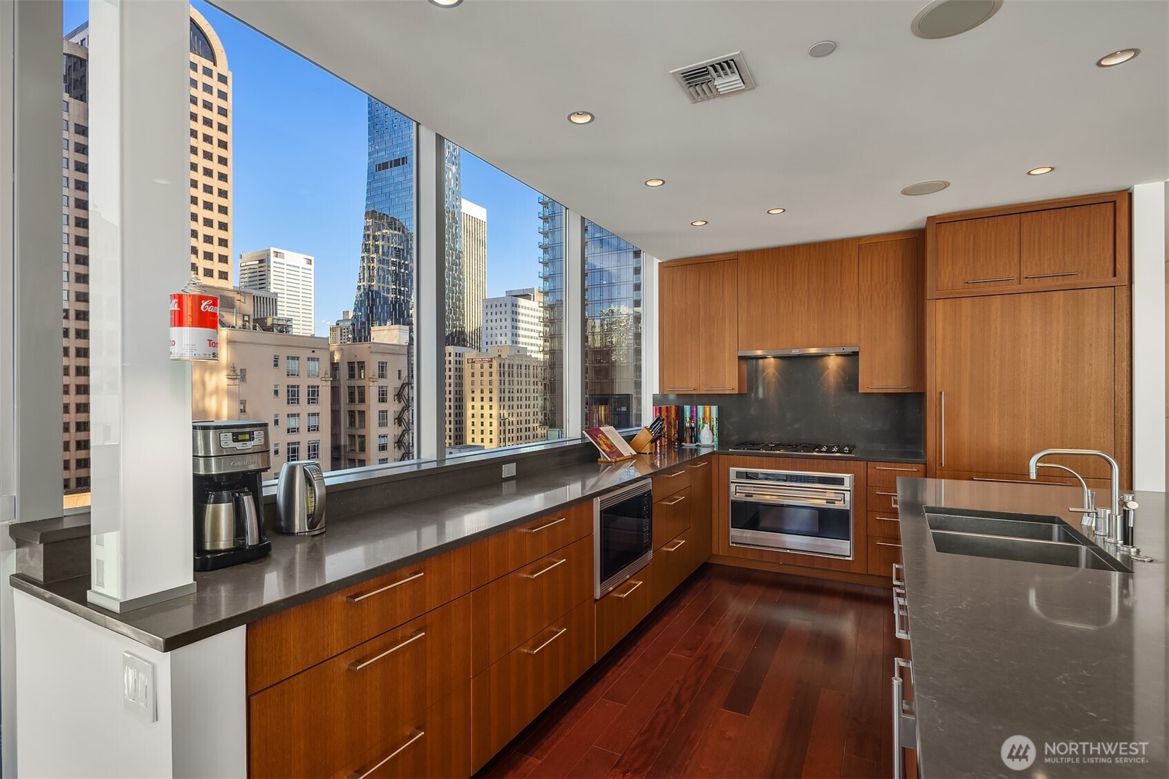 1521 2nd Avenue, Unit 1001 Seattle, WA 98101 - Photo 12 of 37 a kitchen with stainless steel appliances granite countertop a sink stove and refrigerator
