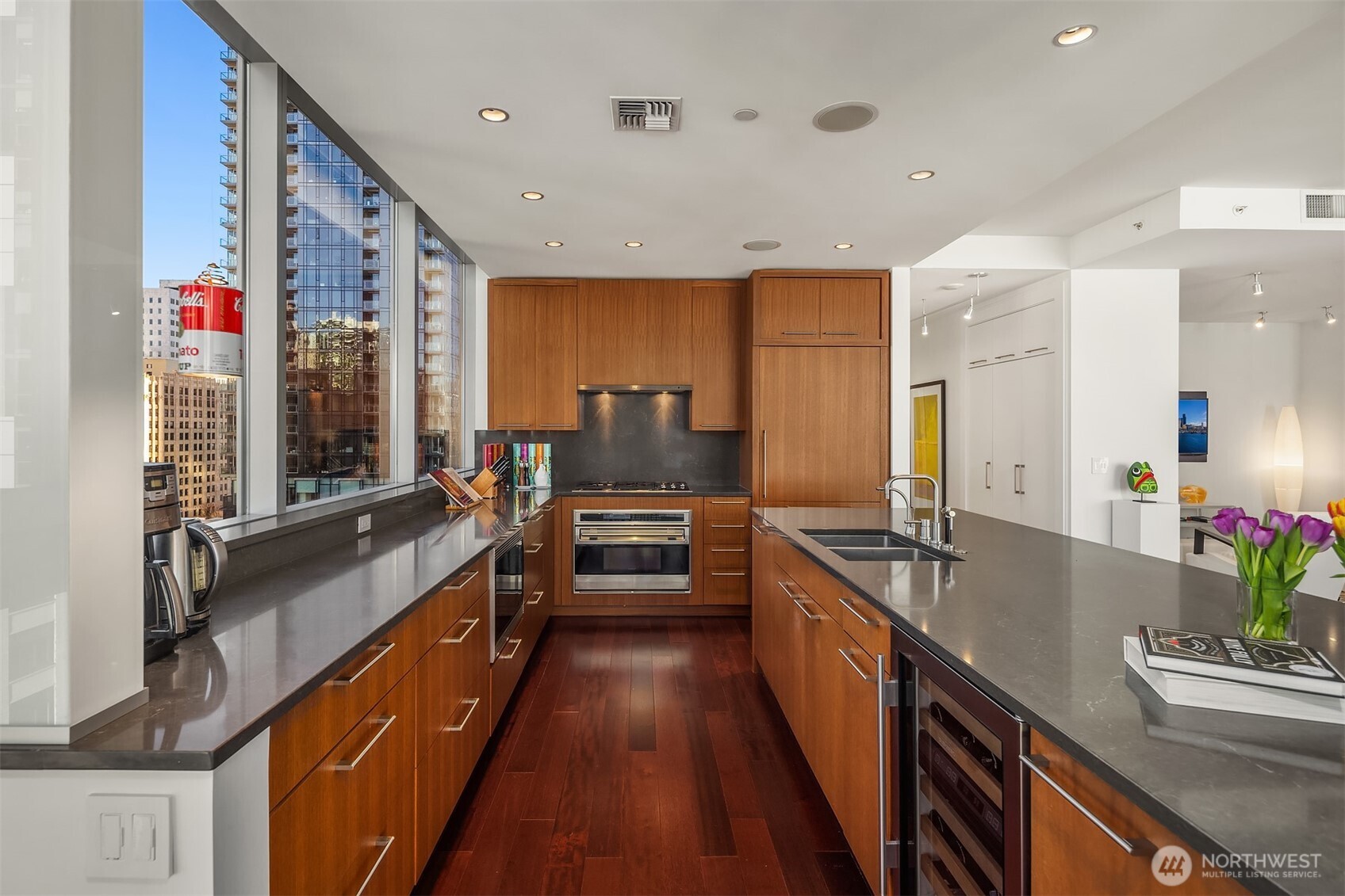 1521 2nd Avenue, Unit 1001 Seattle, WA 98101 - Photo 14 of 37 a large kitchen with a large counter top appliances and cabinets