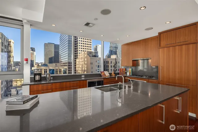 a kitchen with stainless steel appliances granite countertop a sink and a counter top space